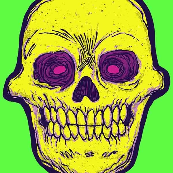 A vintage Halloween skul with dayglow magenta eyes stares with jaws clenched at the viewer with it's terrifying gaze!