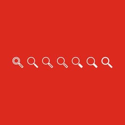Various looks of white magnifying glass icons on Grainger red to determine the best icon design.