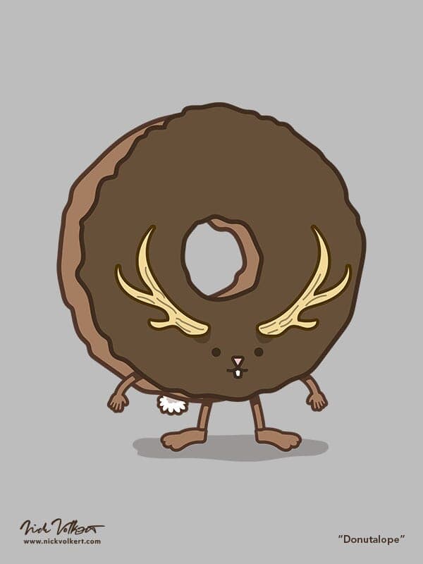 A chocolate donut with a little rabbit face that has a pair of antlers jutting off of it.