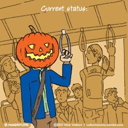 A man with a jack o'lantern for a head on his morning commute.