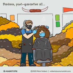 A barber is surrounded by mounds of hair.