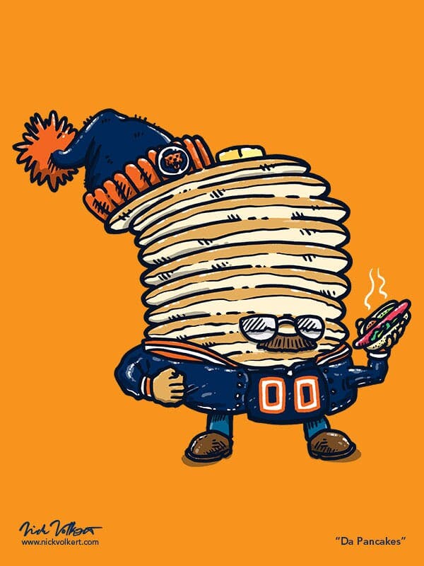Captain Pancake is dressed like a Chicago Bears Superfan, and is holding a chicago-style hot dog.