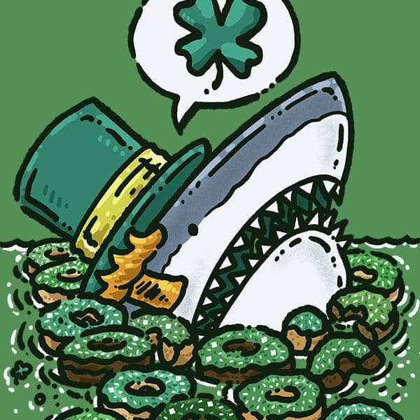 A great white shark peeking out of the water surrounded by a variety of St Patricks Day themed donuts that it is going to devour!